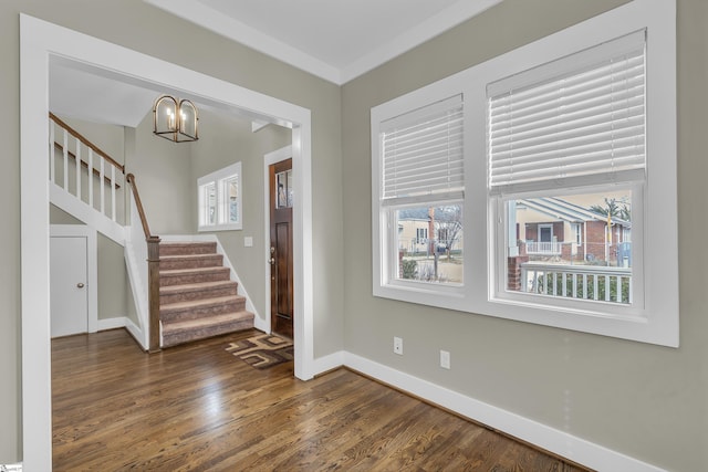 entrance foyer featuring dark hardwood / wood-style floors and an inviting chandelier