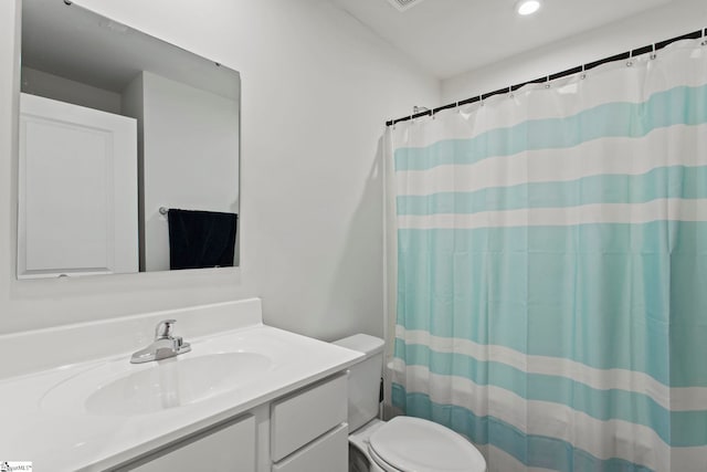 bathroom featuring a shower with curtain, vanity, and toilet