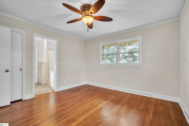 unfurnished bedroom featuring ensuite bathroom, a baseboard radiator, wood-type flooring, ornamental molding, and ceiling fan