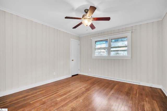 empty room featuring hardwood / wood-style flooring, a baseboard radiator, ornamental molding, and ceiling fan