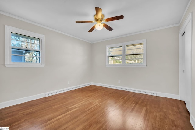 unfurnished bedroom with ceiling fan, ornamental molding, wood-type flooring, and a closet