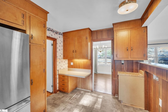 kitchen featuring stainless steel refrigerator and a chandelier