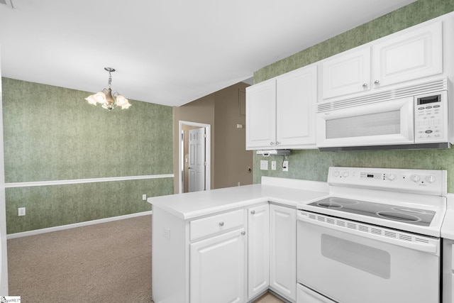 kitchen with white cabinetry, white appliances, kitchen peninsula, and pendant lighting