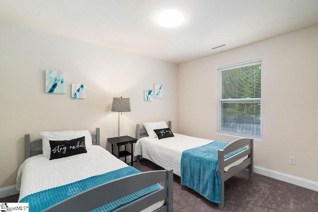 bedroom featuring dark colored carpet