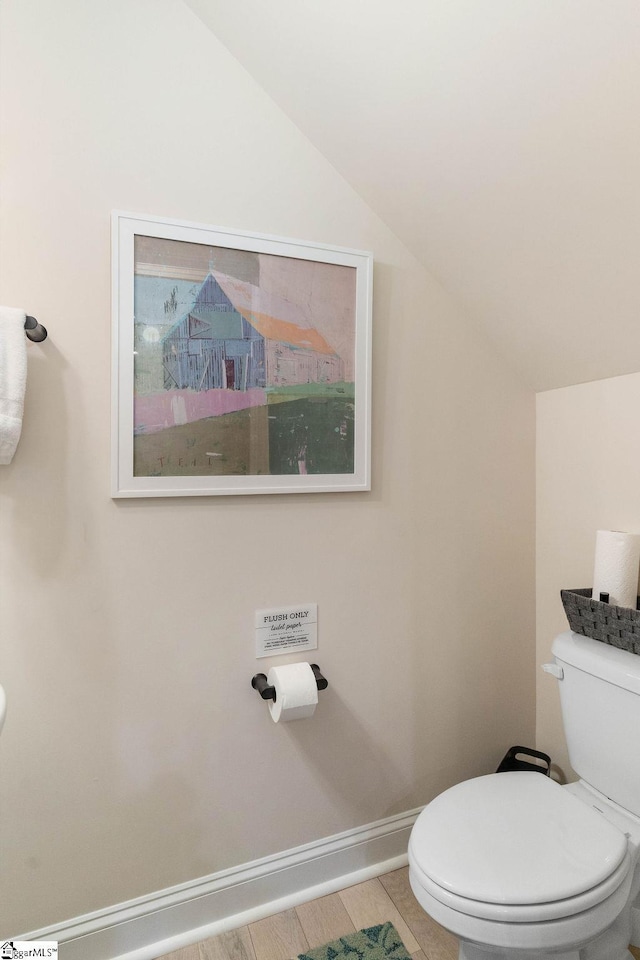 bathroom featuring toilet and vaulted ceiling