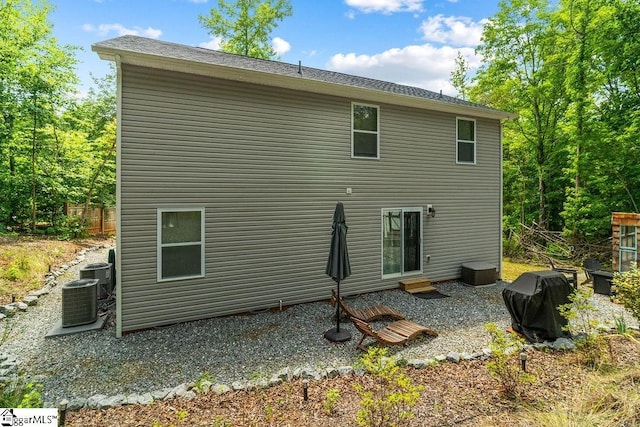 back of house featuring central air condition unit