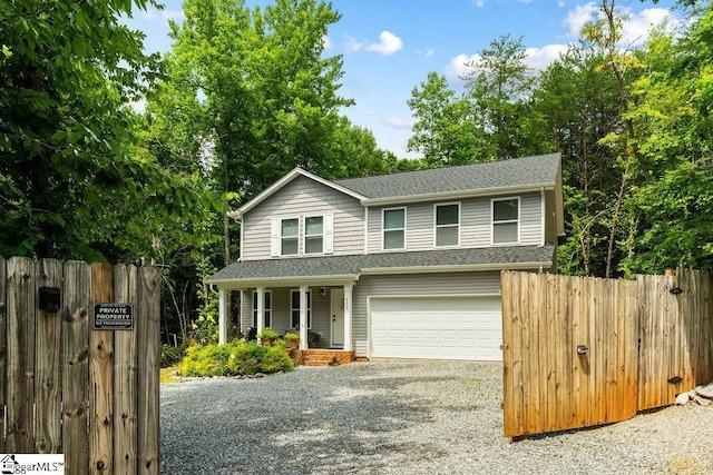 view of front facade featuring a porch and a garage