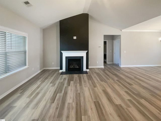 unfurnished living room with lofted ceiling and light hardwood / wood-style flooring