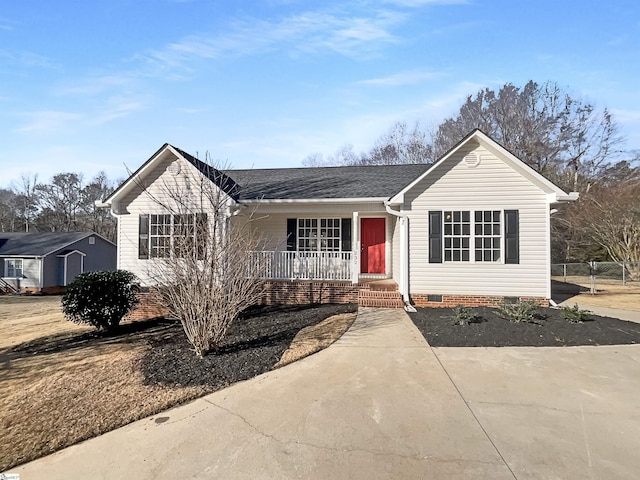 ranch-style house with a shed and covered porch