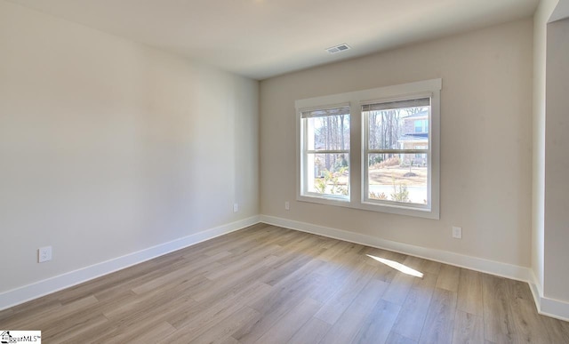 spare room with light hardwood / wood-style flooring