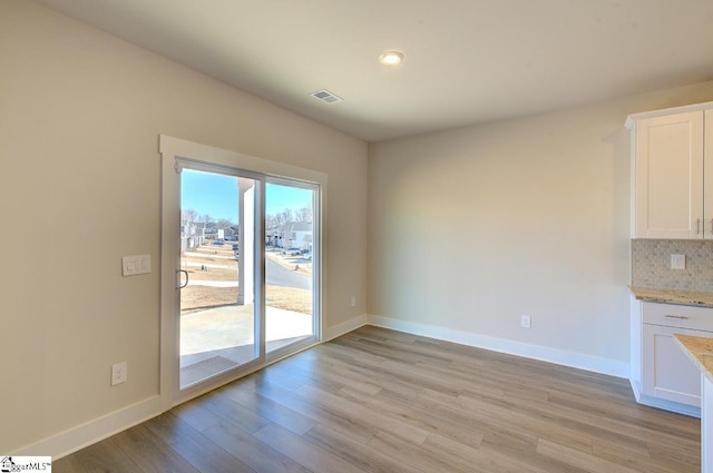 unfurnished dining area with light hardwood / wood-style flooring