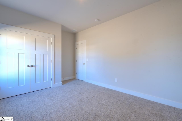 unfurnished bedroom with carpet floors and a closet