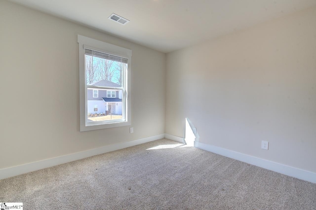 spare room featuring carpet