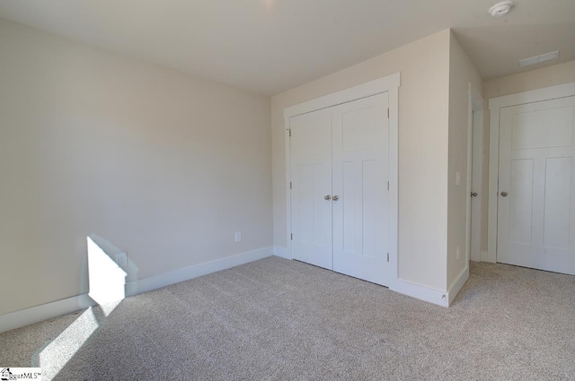 unfurnished bedroom featuring light colored carpet