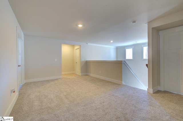 unfurnished room featuring light carpet