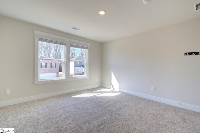 unfurnished room featuring light colored carpet