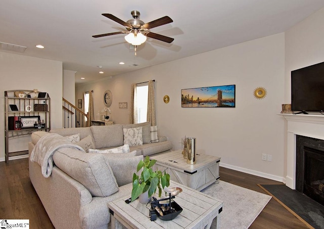 living room featuring dark hardwood / wood-style floors and ceiling fan