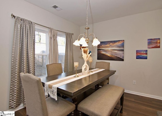 dining room with an inviting chandelier and dark hardwood / wood-style floors