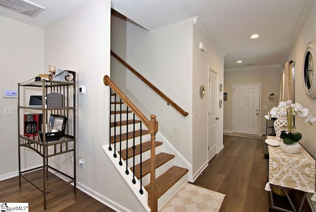 stairs with hardwood / wood-style flooring and crown molding