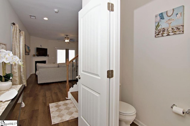 bathroom with ceiling fan, toilet, and hardwood / wood-style floors