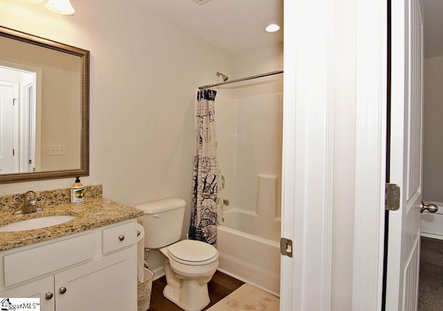 full bathroom featuring shower / tub combo with curtain, vanity, and toilet