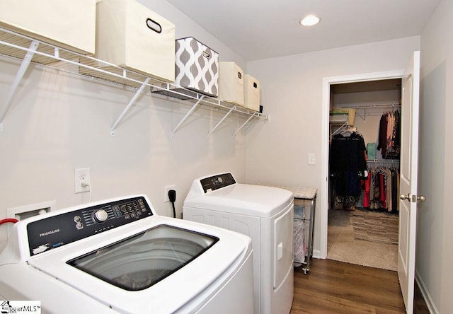 laundry area with dark hardwood / wood-style flooring and independent washer and dryer