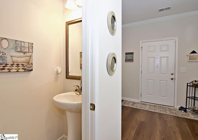 bathroom with crown molding and wood-type flooring