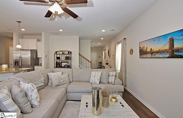 living room featuring hardwood / wood-style flooring and ceiling fan