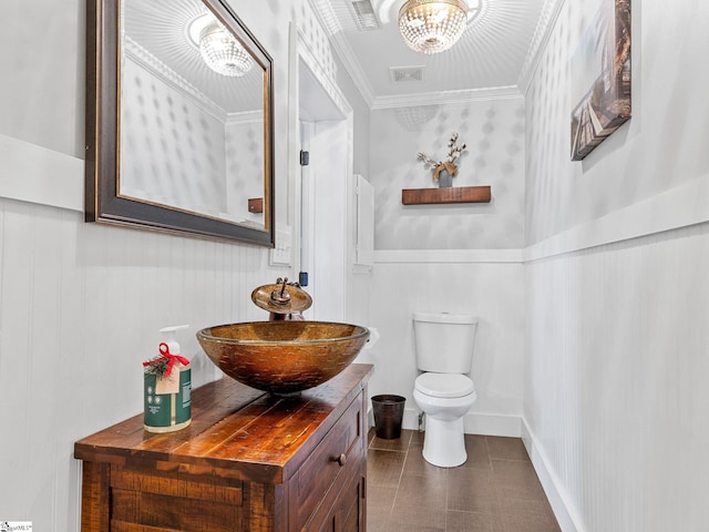 bathroom featuring crown molding, vanity, toilet, and tile patterned flooring