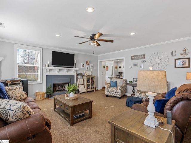 living room featuring ornamental molding, carpet floors, and ceiling fan