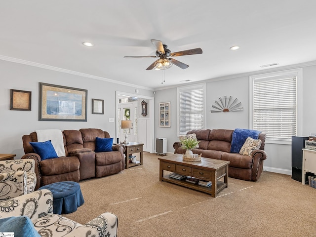 living room with light carpet, crown molding, and ceiling fan