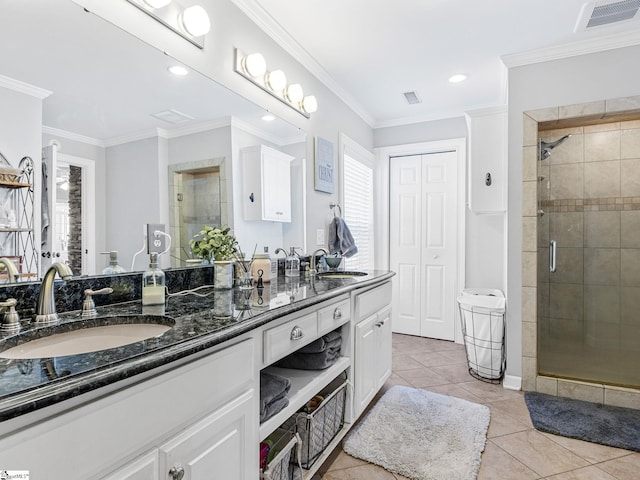 bathroom with a shower with door, crown molding, tile patterned flooring, and vanity