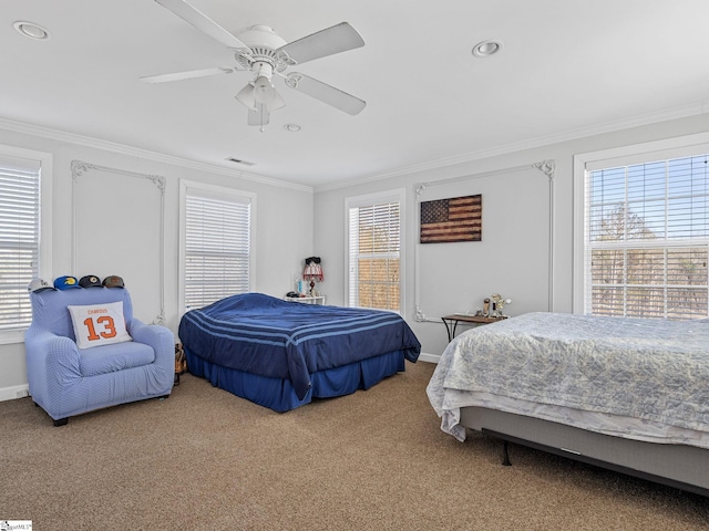 carpeted bedroom featuring ornamental molding and multiple windows