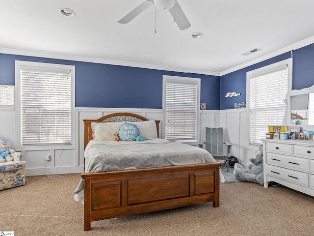 carpeted bedroom featuring ornamental molding and ceiling fan