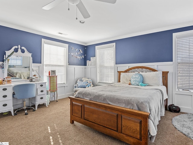 bedroom featuring light carpet, multiple windows, ornamental molding, and ceiling fan