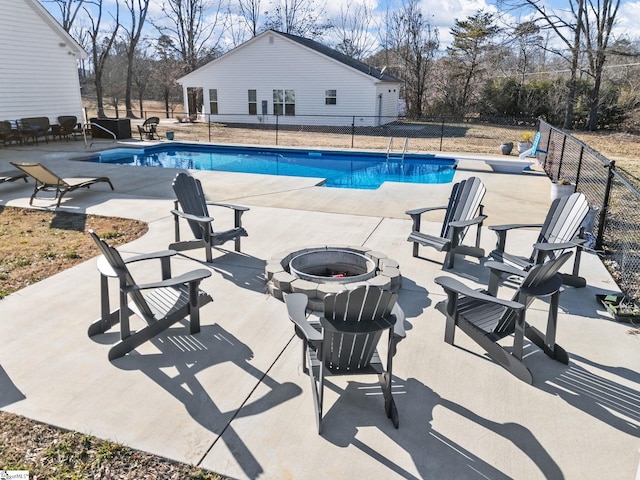 view of pool with a patio and an outdoor fire pit