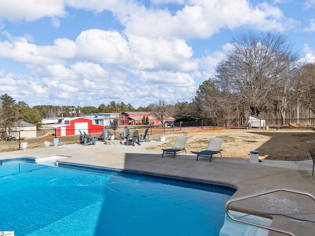 view of swimming pool with a patio area