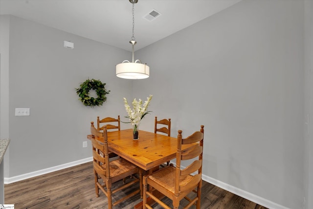 dining area with dark hardwood / wood-style flooring