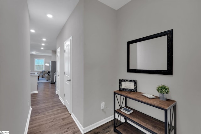 hall with wood-type flooring