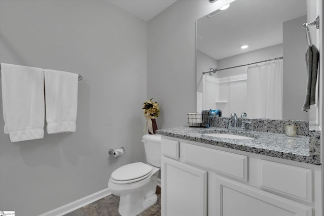 bathroom featuring vanity, a shower with curtain, and toilet