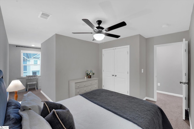 carpeted bedroom with ceiling fan and a closet