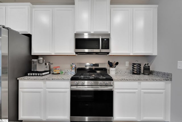 kitchen featuring appliances with stainless steel finishes and white cabinets