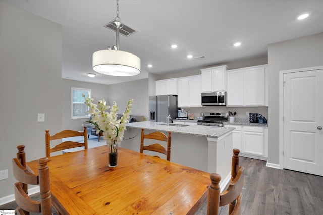 dining room featuring sink and dark wood-type flooring