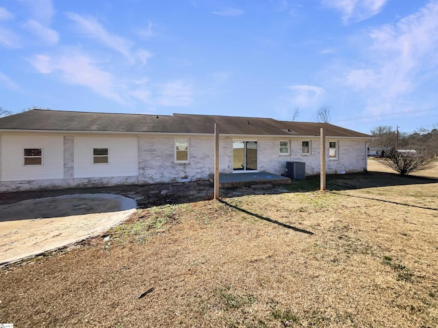 rear view of property with central AC unit