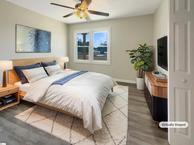 bedroom featuring wood-type flooring and ceiling fan