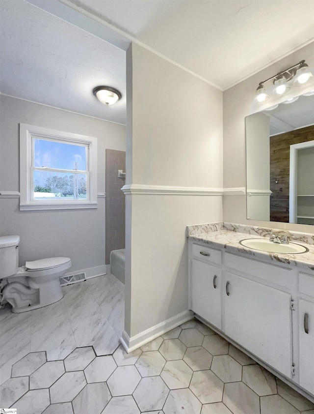 full bathroom featuring vanity, tiled shower / bath, and toilet