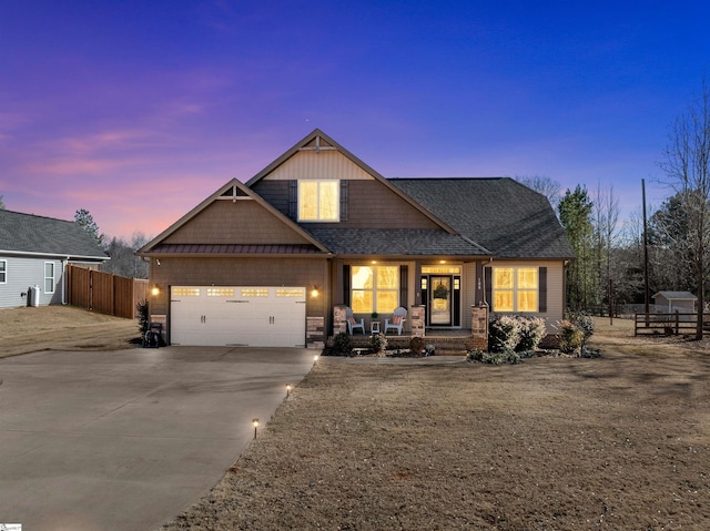 craftsman inspired home with a garage and covered porch