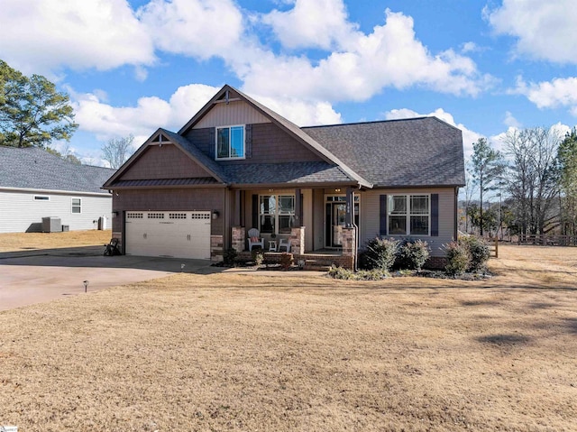 craftsman inspired home with a garage and central AC unit