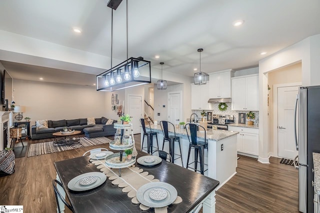 dining room with dark hardwood / wood-style flooring and sink