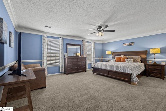 bedroom with crown molding, light colored carpet, a textured ceiling, and ceiling fan